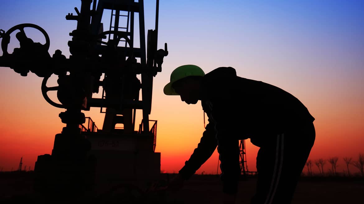Man working in oil field at sunset - Workforce Housing