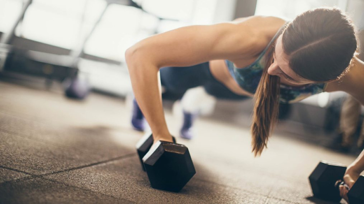 Woman performing T-Push-up with Dumbbells